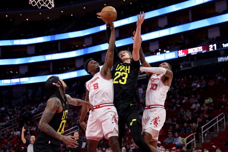 HOUSTON, TEXAS - JANUARY 20: Jae'Sean Tate #8 of the Houston Rockets battles Lauri Markkanen #23 of the Utah Jazz for a rebound in the first half at Toyota Center on January 20, 2024 in Houston, Texas.  NOTE TO USER: User expressly acknowledges and agrees that, by downloading and or using this photograph, User is consenting to the terms and conditions of the Getty Images License Agreement. (Photo by Tim Warner/Getty Images)