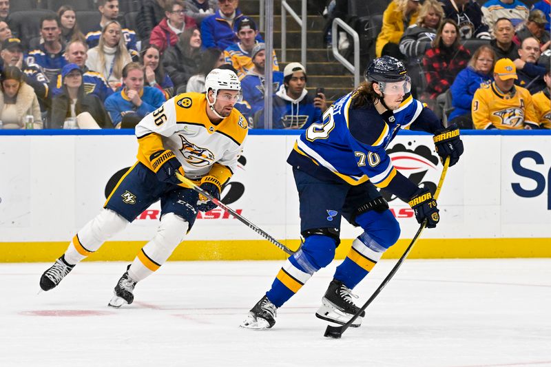 Nov 24, 2023; St. Louis, Missouri, USA;  St. Louis Blues center Oskar Sundqvist (70) controls the puck against the Nashville Predators during the third period at Enterprise Center. Mandatory Credit: Jeff Curry-USA TODAY Sports