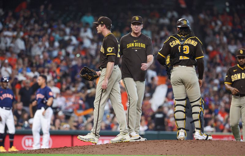 Sep 10, 2023; Houston, Texas, USA; San Diego Padres relief pitcher Tim Hill (25) gives the ball to manager Bob Melvin (3) during a pitching change in the sixth inning against the Houston Astros at Minute Maid Park. Mandatory Credit: Troy Taormina-USA TODAY Sports