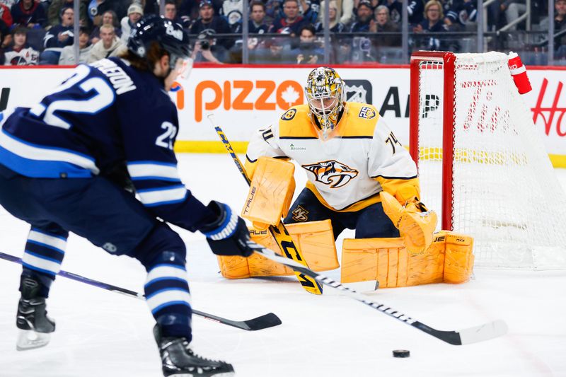 Mar 13, 2024; Winnipeg, Manitoba, CAN; Nashville Predators goalie Juuse Saros (74) watches Winnipeg Jets forward Mason Appleton (22) during the second period at Canada Life Centre. Mandatory Credit: Terrence Lee-USA TODAY Sports