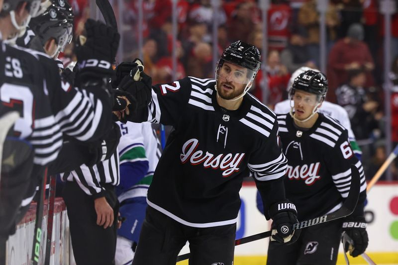 Jan 6, 2024; Newark, New Jersey, USA; New Jersey Devils defenseman Brendan Smith (2) celebrates his goal against the Vancouver Canucks during the third period at Prudential Center. Mandatory Credit: Ed Mulholland-USA TODAY Sports