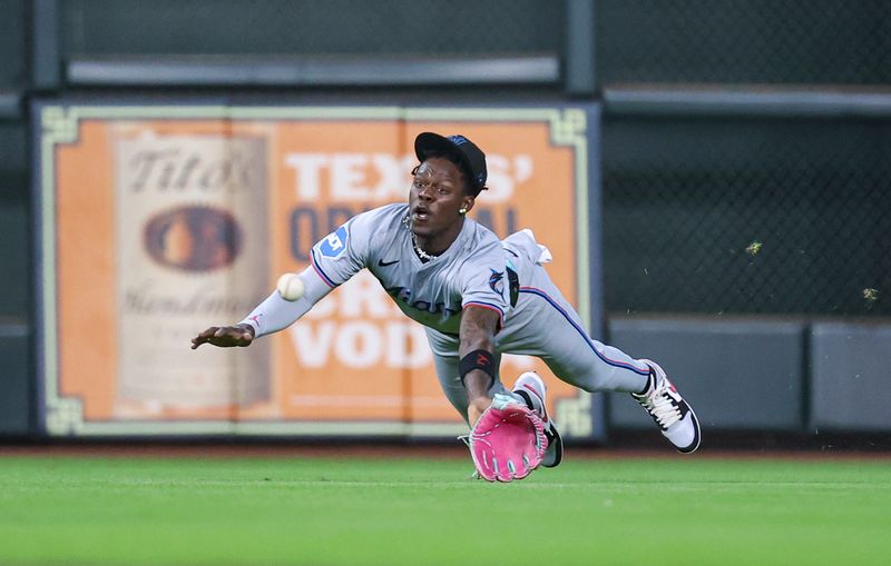 Jul 10, 2024; Houston, Texas, USA; Miami Marlins center fielder Jazz Chisholm Jr (2) dives but is unable to catch a fly ball during the first inning against the Houston Astros at Minute Maid Park. Mandatory Credit: Troy Taormina-USA TODAY Sports