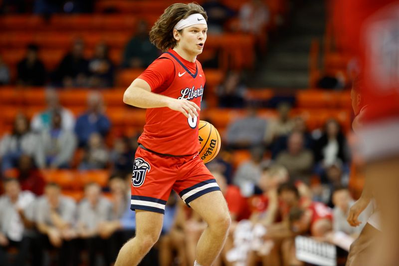 Feb 3, 2024; El Paso, Texas, USA; Liberty University Flames guard Colin Porter (0) dribbles the ball against the UTEP Miners defense in the first half at Don Haskins Center. Mandatory Credit: Ivan Pierre Aguirre-USA TODAY Sports