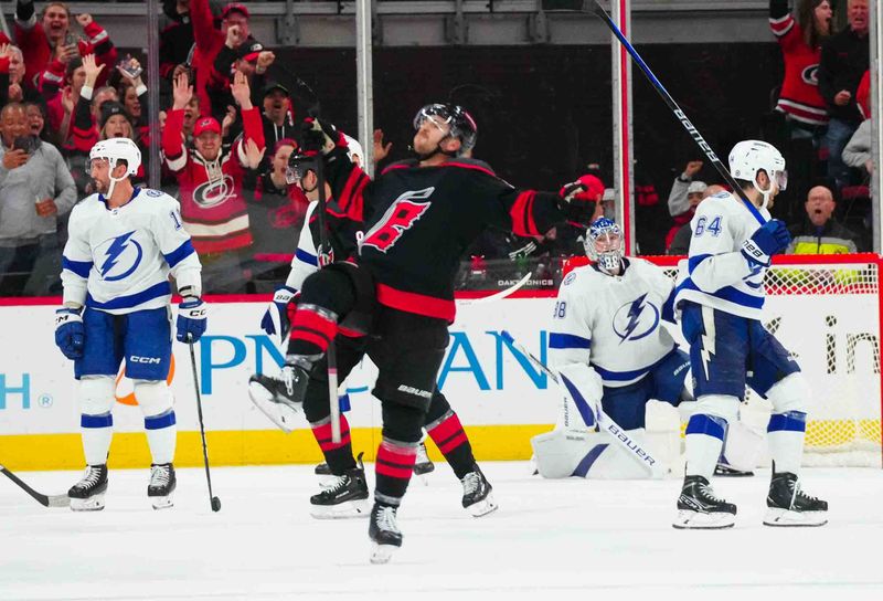 Nov 24, 2023; Raleigh, North Carolina, USA; Carolina Hurricanes left wing Michael Bunting (58) celebrates his goal past Tampa Bay Lightning goaltender Andrei Vasilevskiy (88) during the second period at PNC Arena. Mandatory Credit: James Guillory-USA TODAY Sports