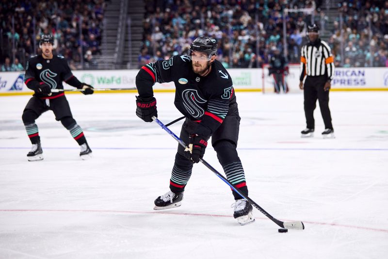 Nov 1, 2025; Seattle, Washington, USA; Seattle Kraken defenseman Ryan Lindgren (55) looks to pass during the third period against the New York Rangers at Climate Pledge Arena. Mandatory Credit: Blake Dahlin-Imagn Images