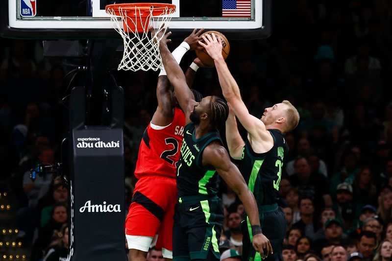 BOSTON, MA - NOVEMBER 16: Sam Hauser #30 of the Boston Celtics and Jaylen Brown #7 team up to stop Jamal Shead #23 of the Toronto Raptors from going to the basket during the second quarter at TD Garden on November 16, 2024 in Boston, Massachusetts. NOTE TO USER: User expressly acknowledges and agrees that, by downloading and/or using this Photograph, user is consenting to the terms and conditions of the Getty Images License Agreement. (Photo By Winslow Townson/Getty Images)