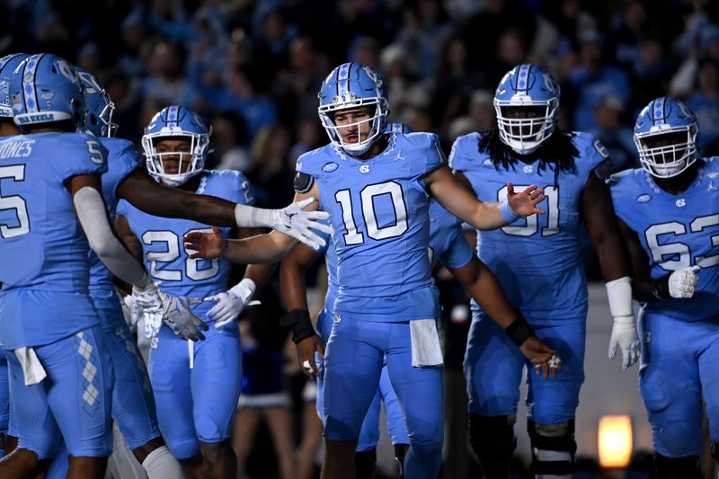 Nov 11, 2023; Chapel Hill, North Carolina, USA; North Carolina Tar Heels quarterback Drake Maye (10) celebrates after scoring a touchdown in the first quarter at Kenan Memorial Stadium. Mandatory Credit: Bob Donnan-USA TODAY Sports