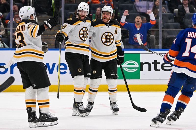 Nov 27, 2024; Elmont, New York, USA;  Boston Bruins center Pavel Zacha (18) celebrates his goal against the New York Islanders with Boston Bruins right wing David Pastrnak (88) and Boston Bruins left wing Brad Marchand (63) during the third period at UBS Arena. Mandatory Credit: Dennis Schneidler-Imagn Images