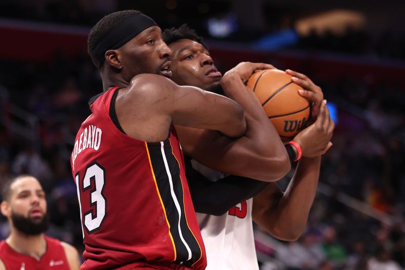 DETROIT, MICHIGAN - MARCH 17: Bam Adebayo #13 of the Miami Heat battles for the ball against James Wiseman #13 of the Detroit Pistons during the second half at Little Caesars Arena on March 17, 2024 in Detroit, Michigan. Miami won the game 104-101. NOTE TO USER: User expressly acknowledges and agrees that, by downloading and or using this photograph, User is consenting to the terms and conditions of the Getty Images License.  (Photo by Gregory Shamus/Getty Images)