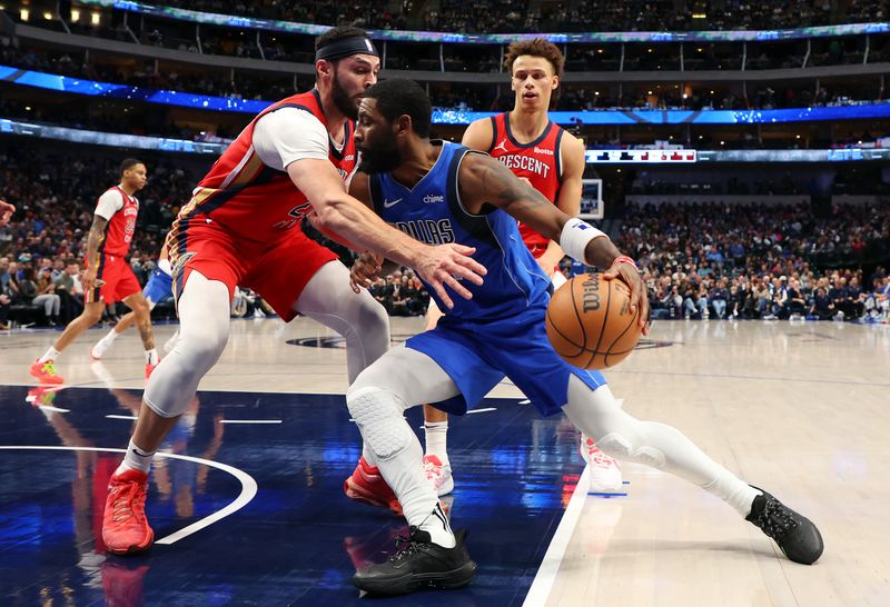 DALLAS, TEXAS - JANUARY 13: Larry Nance Jr. #22 of the New Orleans Pelicans defends as Kyrie Irving #11 of the Dallas Mavericks drives to the basket in the first half of an NBA basketball game at American Airlines Center on January 13, 2024 in Dallas, Texas. NOTE TO USER: User expressly acknowledges and agrees that, by downloading and or using this photograph, User is consenting to the terms and conditions of the Getty Images License Agreement. (Photo by Richard Rodriguez/Getty Images)