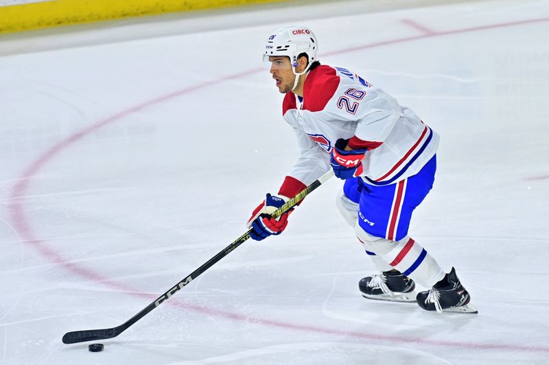 Nov 2, 2023; Tempe, Arizona, USA;  Montreal Canadiens defenseman Johnathan Kovacevic (26) carries the puck in the first period against the Arizona Coyotes at Mullett Arena. Mandatory Credit: Matt Kartozian-USA TODAY Sports