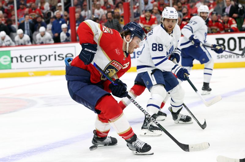 May 11, 2025; Sunrise, Florida, USA; Florida Panthers left wing Matthew Tkachuk (19) and Toronto Maple Leafs right wing William Nylander (88) skate to control the puck during the third period in game four of the second round of the 2025 Stanley Cup Playoffs at Amerant Bank Arena. Mandatory Credit: Kim Klement Neitzel-Imagn Images