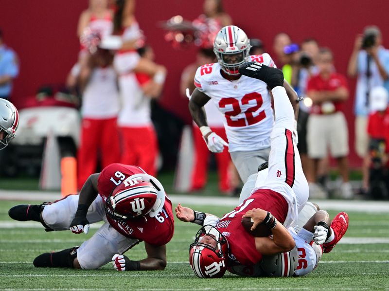 Sep 2, 2023; Bloomington, Indiana, USA; Indiana Hoosiers quarterback Brendan Sorsby (15) is sacked by Ohio State Buckeyes defensive tackle Jaden McKenzie (90) during the second half at Memorial Stadium. Mandatory Credit: Marc Lebryk-USA TODAY Sports