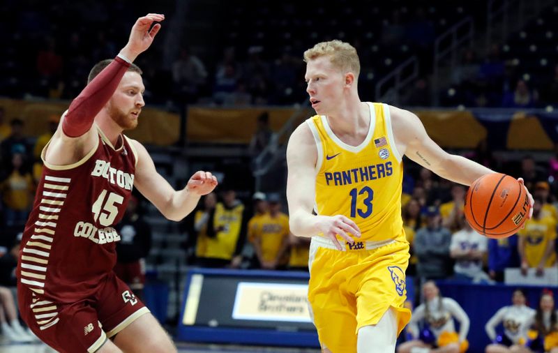 Feb 14, 2023; Pittsburgh, Pennsylvania, USA;  Pittsburgh Panthers forward Aidan Fisch (13) dribbles the ball as Boston College Eagles guard Mason Madsen (45) defends during the second half at the Petersen Events Center. Pittsburgh won 77-58. Mandatory Credit: Charles LeClaire-USA TODAY Sports