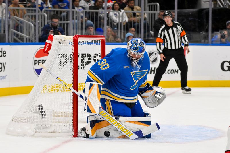 Oct 19, 2024; St. Louis, Missouri, USA;  St. Louis Blues goaltender Joel Hofer (30) defends the net against the Carolina Hurricanes during the first period at Enterprise Center. Mandatory Credit: Jeff Curry-Imagn Images