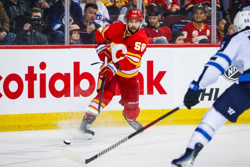 Feb 19, 2024; Calgary, Alberta, CAN; Calgary Flames defenseman Oliver Kylington (58) passes the puck against the Winnipeg Jets during the third period at Scotiabank Saddledome. Mandatory Credit: Sergei Belski-USA TODAY Sports