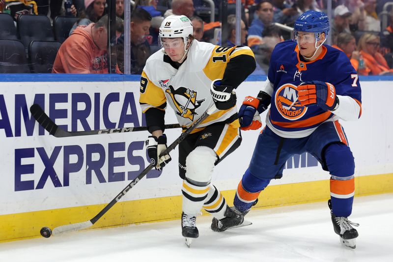 Nov 5, 2024; Elmont, New York, USA; Pittsburgh Penguins center Cody Glass (19) controls the puck against New York Islanders right wing Maxim Tsyplakov (7) during the first period at UBS Arena. Mandatory Credit: Brad Penner-Imagn Images