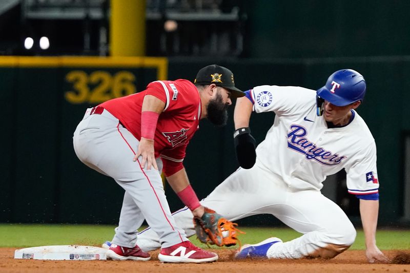 May 18, 2024; Arlington, Texas, USA; Texas Rangers shortstop Corey Seager (5) tags up  safely as Los Angeles Angels second baseman Luis Guillorme (15) applies the tag during the eighth inning at Globe Life Field. Mandatory Credit: Raymond Carlin III-USA TODAY Sports