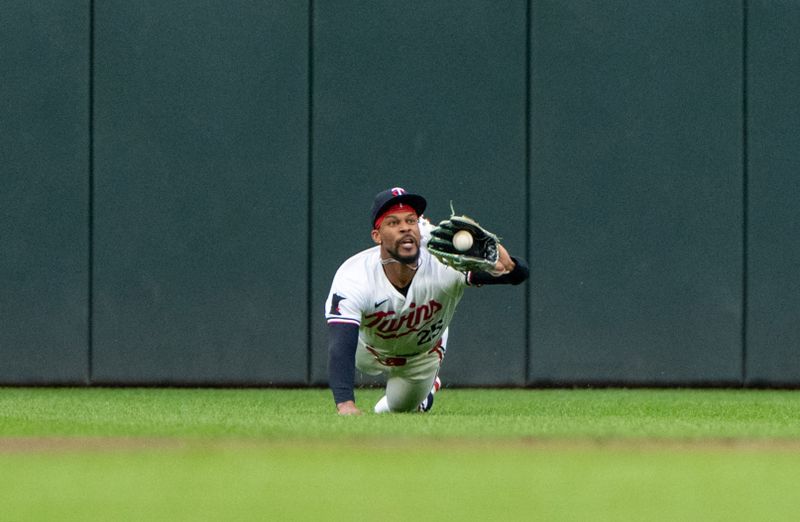 Jul 2, 2024; Minneapolis, Minnesota, USA; Minnesota Twins center fielder Byron Buxton (25) makes a diving catch to retire Detroit Tigers center fielder Riley Greene (31) in the first inning at Target Field. Mandatory Credit: Matt Blewett-USA TODAY Sports