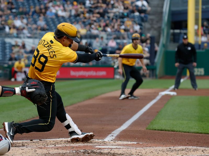 Jun 7, 2024; Pittsburgh, Pennsylvania, USA;  Pittsburgh Pirates second baseman Nick Gonzales (39) drives in a run with a sacrifice fly against the Minnesota Twins during the fourth inning at PNC Park. Mandatory Credit: Charles LeClaire-USA TODAY Sports