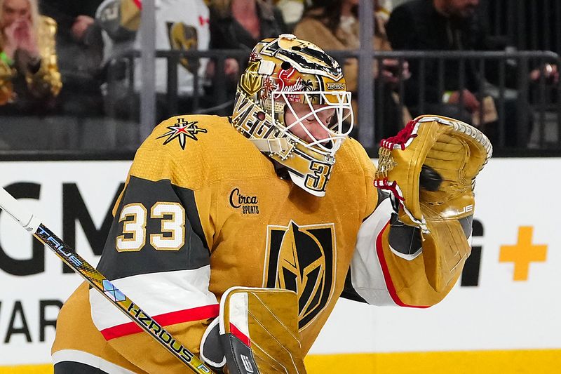 Feb 6, 2024; Las Vegas, Nevada, USA; Vegas Golden Knights goaltender Adin Hill (33) makes a glove save against the Edmonton Oilers during the second period at T-Mobile Arena. Mandatory Credit: Stephen R. Sylvanie-USA TODAY Sports