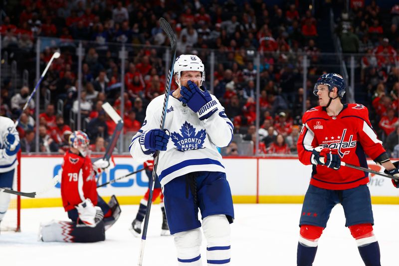 Mar 20, 2024; Washington, District of Columbia, USA; Toronto Maple Leafs defenseman Jake McCabe (22) celebrates after scoring a goal against the Washington Capitals during the second period at Capital One Arena. Mandatory Credit: Amber Searls-USA TODAY Sports