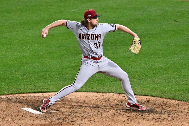 Oct 24, 2023; Philadelphia, Pennsylvania, USA; Arizona Diamondbacks relief pitcher Kevin Ginkel (37) throws a pitch against the Philadelphia Phillies in the eighth inning during game seven of the NLCS for the 2023 MLB playoffs at Citizens Bank Park. Mandatory Credit: Kyle Ross-USA TODAY Sports