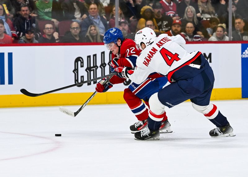 Oct 21, 2023; Montreal, Quebec, CAN; Washington Capitals defenseman Hardy Haman Aktell (4) defends the puck against Montreal Canadiens right wing Cole Caufield (22) during the second period at Bell Centre. Mandatory Credit: David Kirouac-USA TODAY Sports