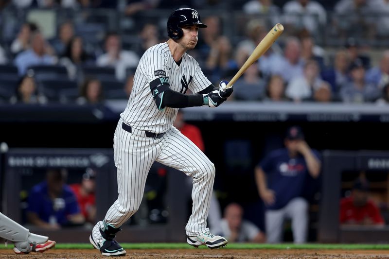 Jun 6, 2025; Bronx, New York, USA; New York Yankees left fielder Cody Bellinger (35) follows through on a double against the Boston Red Sox during the fourth inning at Yankee Stadium. Mandatory Credit: Brad Penner-Imagn Images