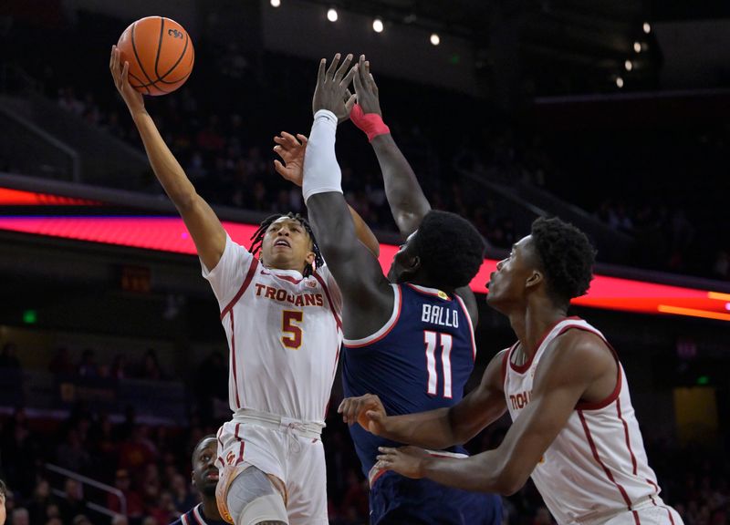 Mar 2, 2023; Los Angeles, California, USA;  USC Trojans guard Boogie Ellis (5) drives past Arizona Wildcats center Oumar Ballo (11) in the first half at Galen Center. Mandatory Credit: Jayne Kamin-Oncea-USA TODAY Sports