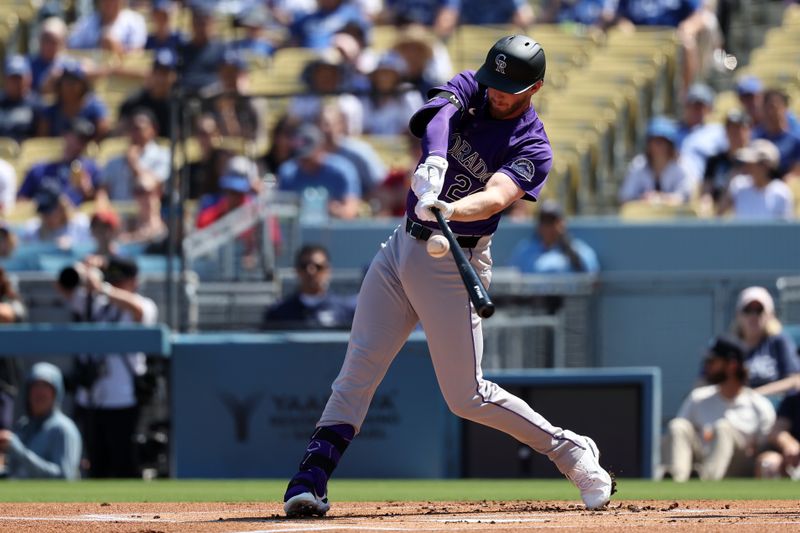 Sep 22, 2024; Los Angeles, California, USA;  Colorado Rockies third baseman Ryan McMahon (24) hits a single during the first inning against the Los Angeles Dodgers at Dodger Stadium. Mandatory Credit: Kiyoshi Mio-Imagn Images