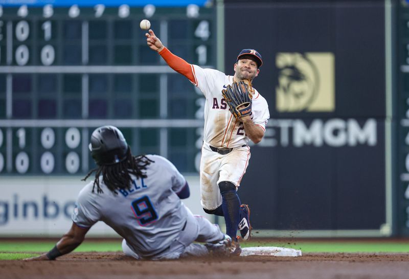 Jul 10, 2024; Houston, Texas, USA; Miami Marlins designated hitter Josh Bell (9) is out and Houston Astros second baseman Jose Altuve (27) throws to first base to complete a double play during the second inning at Minute Maid Park. Mandatory Credit: Troy Taormina-USA TODAY Sports