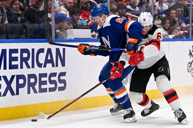 Mar 24, 2024; Elmont, New York, USA;  New Jersey Devils defenseman John Marino (6) and New York Islanders right wing Hudson Fasching (20) battle for the puck along the boards during the second period at UBS Arena. Mandatory Credit: Dennis Schneidler-USA TODAY Sports