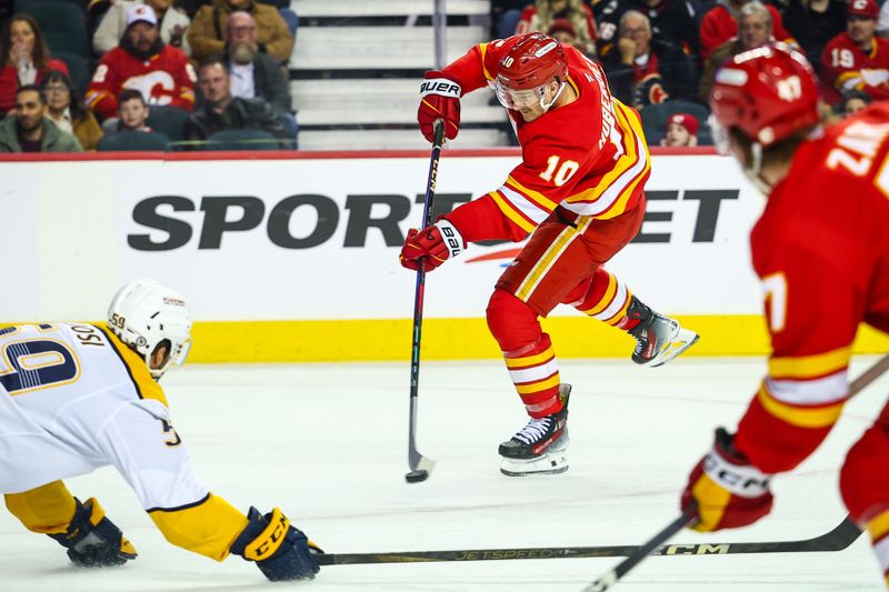 Nov 15, 2024; Calgary, Alberta, CAN; Calgary Flames center Jonathan Huberdeau (10) shoots the puck against the Nashville Predators during the second period at Scotiabank Saddledome. Mandatory Credit: Sergei Belski-Imagn Images