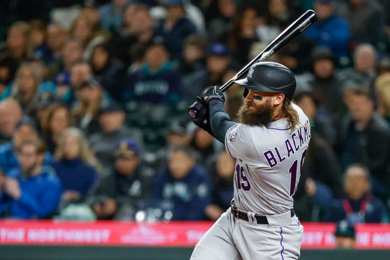 Apr 14, 2023; Seattle, Washington, USA; Colorado Rockies designated hitter Charlie Blackmon (19) hits a single against the Seattle Mariners during the sixth inning at T-Mobile Park. Mandatory Credit: Joe Nicholson-USA TODAY Sports