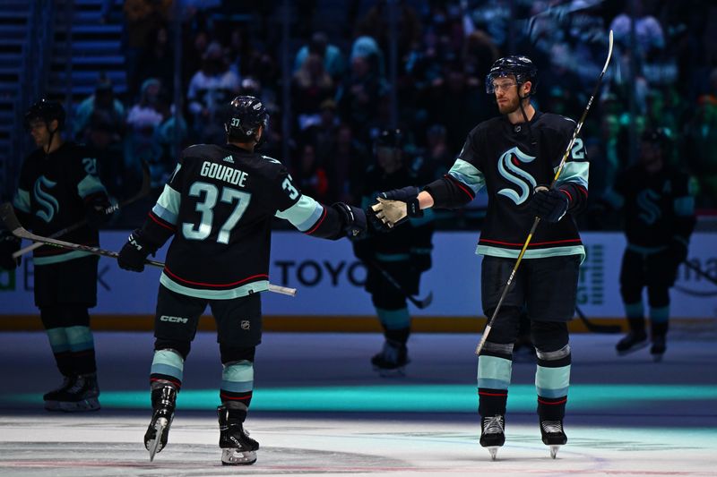 Feb 16, 2023; Seattle, Washington, USA; Seattle Kraken center Yanni Gourde (37) and defenseman Jamie Oleksiak (24) celebrate after defeating the Philadelphia Flyers at Climate Pledge Arena. Seattle defeated Philadelphia 6-2. Mandatory Credit: Steven Bisig-USA TODAY Sports