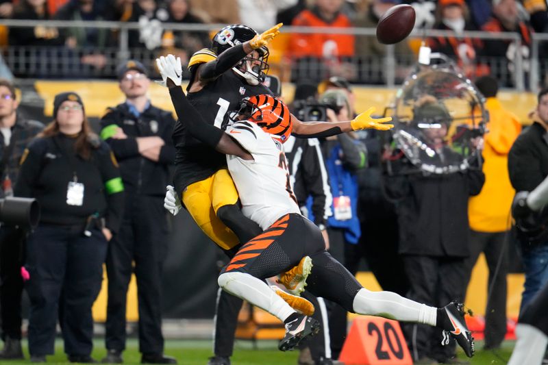 Pittsburgh Steelers wide receiver Calvin Austin III (19) can't catch the pass over Cincinnati Bengals cornerback Mike Hilton (21) during the first half of an NFL football game Saturday, Dec. 23, 2023, in Pittsburgh. (AP Photo/Gene J. Puskar)