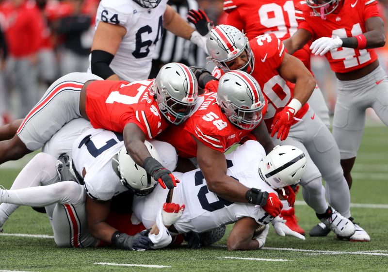 Oct 21, 2023; Columbus, Ohio, USA;  Penn State Nittany Lions running back Kaytron Allen (13) is tackled by Ohio State Buckeyes defensive tackle Ty Hamilton (58) and defensive end Kenyatta Jackson Jr. (97) and linebacker Cody Simon (30) during the second quarter at Ohio Stadium. Mandatory Credit: Joseph Maiorana-USA TODAY Sports