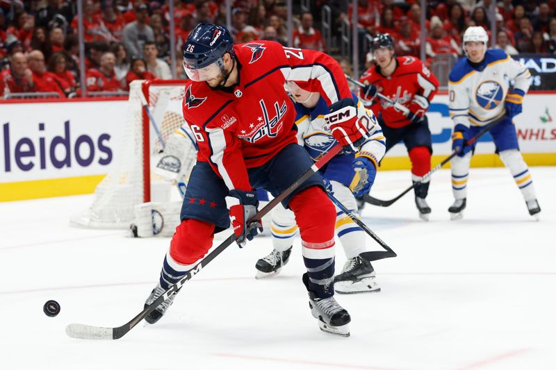 Nov 22, 2023; Washington, District of Columbia, USA; Washington Capitals right wing Nic Dowd (26) controls the puck in front of Buffalo Sabres defenseman Rasmus Dahlin (26) in the first period at Capital One Arena. Mandatory Credit: Geoff Burke-USA TODAY Sports