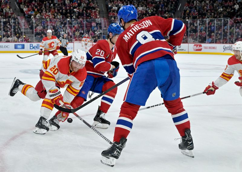 Nov 14, 2023; Montreal, Quebec, CAN; Calgary Flames forward Blake Coleman (20) chases the puck and Montreal Canadiens forward Juraj Slafkovsky (20) defends with teammate defenseman Mike Matheson (8) during the second period at the Bell Centre. Mandatory Credit: Eric Bolte-USA TODAY Sports