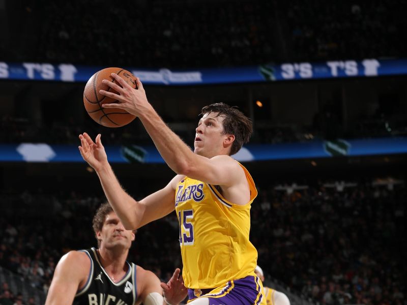 MILWAUKEE, WI - MARCH 26: Austin Reaves #15 of the Los Angeles Lakers dribbles the ball during the game against the Milwaukee Bucks on March 26, 2024 at the Fiserv Forum Center in Milwaukee, Wisconsin. NOTE TO USER: User expressly acknowledges and agrees that, by downloading and or using this Photograph, user is consenting to the terms and conditions of the Getty Images License Agreement. Mandatory Copyright Notice: Copyright 2024 NBAE (Photo by Gary Dineen/NBAE via Getty Images).