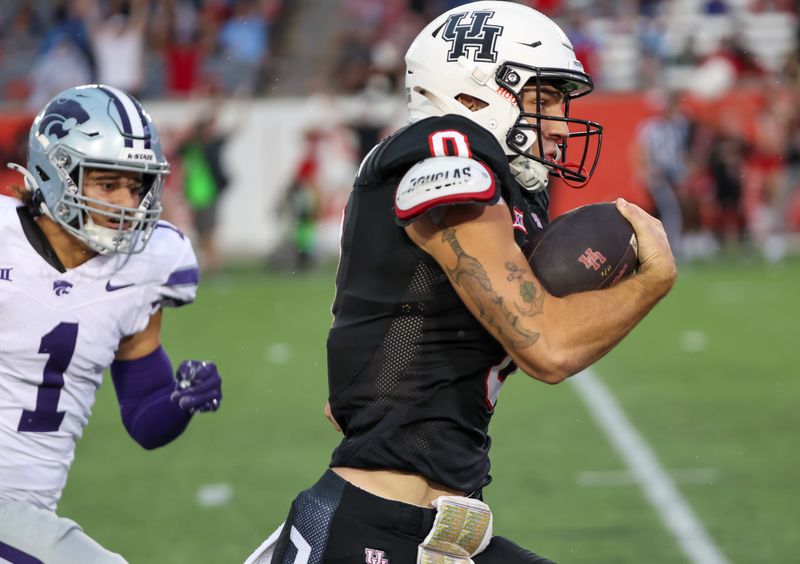 Nov 2, 2024; Houston, Texas, USA; Kansas State Wildcats cornerback Keenan Garber (1) chases Houston Cougars wide receiver Joseph Manjack IV (0) in the first quarter at TDECU Stadium. Mandatory Credit: Thomas B. Shea-Imagn Images