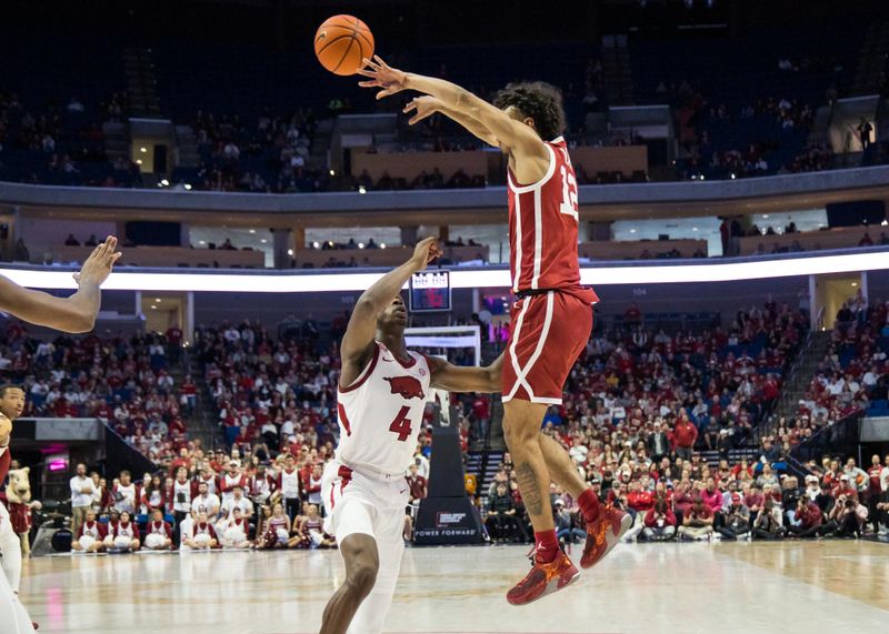 Dec 10, 2022; Tulsa, Oklahoma, USA;  Oklahoma Sooners guard Milos Uzan (12) jumps to pass the ball over Arkansas Razorbacks guard Davonte Davis (4) during the first half at BOK Center. Arkansas won 88-78. Mandatory Credit: Brett Rojo-USA TODAY Sports