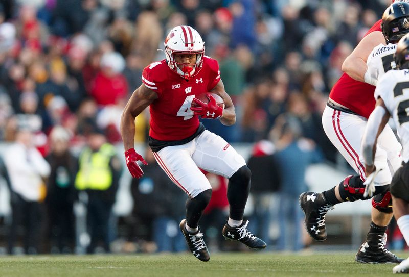 Nov 23, 2019; Madison, WI, USA; Wisconsin Badgers wide receiver A.J. Taylor (4) rushes with the football during the second quarter against the Purdue Boilermakers at Camp Randall Stadium. Mandatory Credit: Jeff Hanisch-USA TODAY Sports