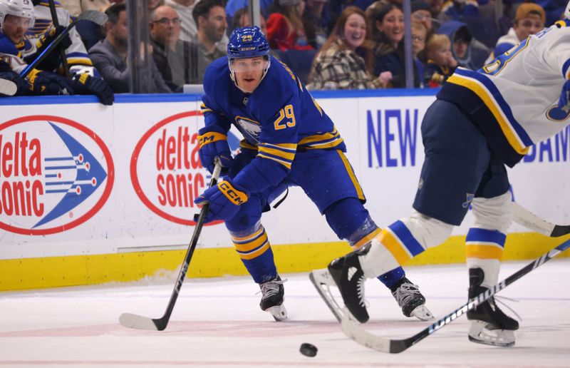 Nov 14, 2024; Buffalo, New York, USA;  Buffalo Sabres left wing Beck Malenstyn (29) clears the puck up ice during the second period against the St. Louis Blues at KeyBank Center. Mandatory Credit: Timothy T. Ludwig-Imagn Images