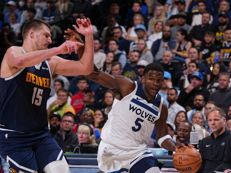 DENVER, CO - APRIL 10: Anthony Edwards #5 of the Minnesota Timberwolves drives to the basket against Nikola Jokic #15 of the Denver Nuggets during the game on April 10, 2024 at the Ball Arena in Denver, Colorado. NOTE TO USER: User expressly acknowledges and agrees that, by downloading and/or using this Photograph, user is consenting to the terms and conditions of the Getty Images License Agreement. Mandatory Copyright Notice: Copyright 2024 NBAE (Photo by Bart Young/NBAE via Getty Images)