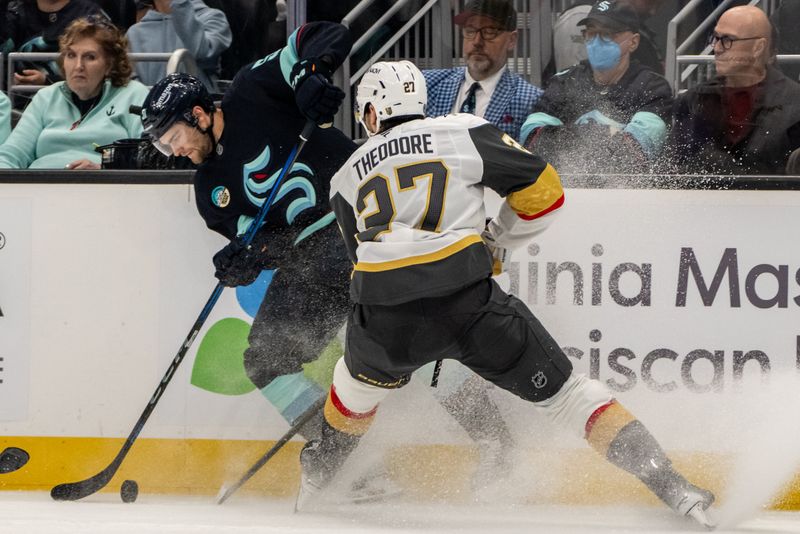 Nov 8, 2024; Seattle, Washington, USA;  Seattle Kraken forward Shane Wright (51) and Vegas Golden Knights defenseman Shea Theodore (27) battle for the puck during the second period at Climate Pledge Arena. Mandatory Credit: Stephen Brashear-Imagn Images