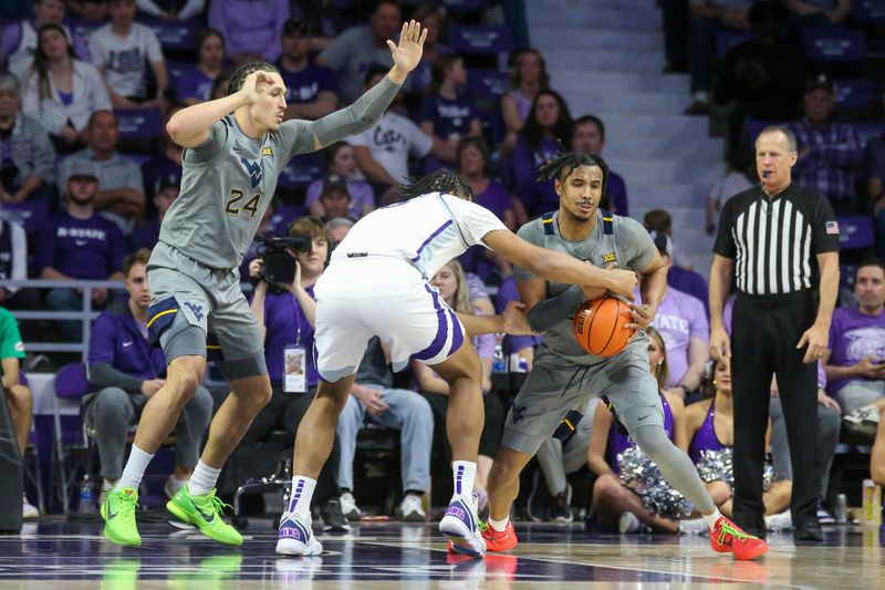 Feb 26, 2024; Manhattan, Kansas, USA; West Virginia Mountaineers forward Josiah Harris (22) steals the ball from Kansas State Wildcats center Will McNair Jr. (13) during the second half at Bramlage Coliseum. Mandatory Credit: Scott Sewell-USA TODAY Sports