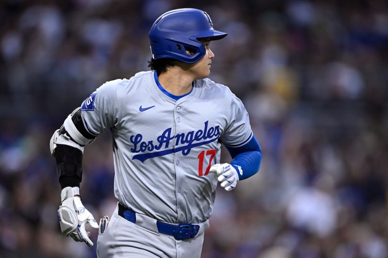 May 10, 2024; San Diego, California, USA; Los Angeles Dodgers designated hitter Shohei Ohtani (17) watches his single against the San Diego Padres during the third inning at Petco Park. Mandatory Credit: Orlando Ramirez-USA TODAY Sports