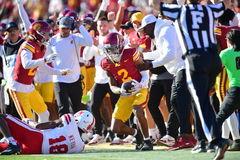 Nov 16, 2024; Los Angeles, California, USA; Southern California Trojans cornerback Jaylin Smith (2) intercepts a pass intended for Nebraska Cornhuskers wide receiver Isaiah Neyor (18) during the first half at the Los Angeles Memorial Coliseum. Mandatory Credit: Gary A. Vasquez-Imagn Images